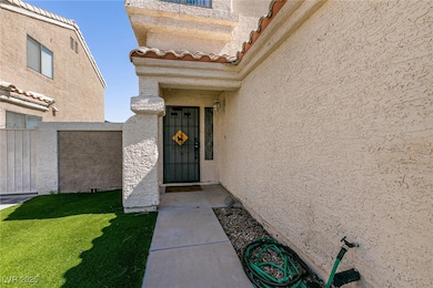 Doorway to property featuring stucco siding and a