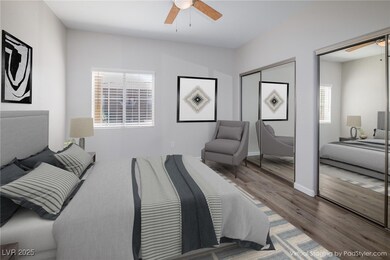 Bedroom with multiple closets, a ceiling fan, base