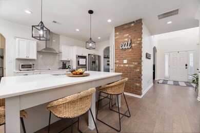 Brick accent wall on pantry, oversized island.