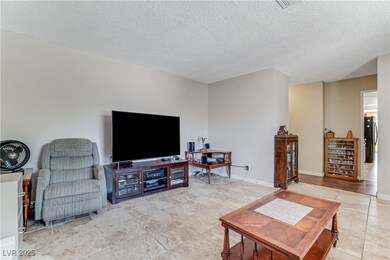 Living area featuring a textured ceiling and light
