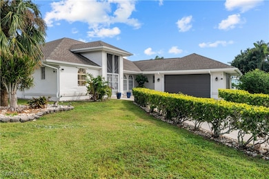 Ranch-style house featuring a front lawn and a gar