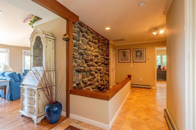 Entrance Hallway anchored by river rock wall
