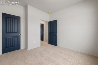 Unfurnished bedroom featuring carpet and baseboards