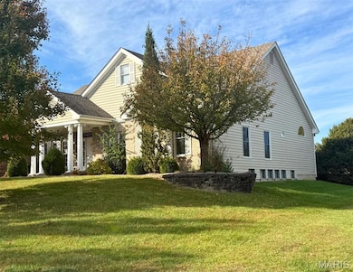 View of home's exterior with a yard and a shingled roof