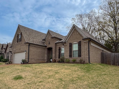 View of front of property featuring fence, brick s