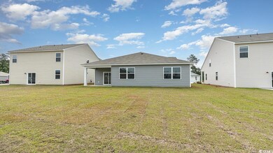 Rear view of property featuring a yard