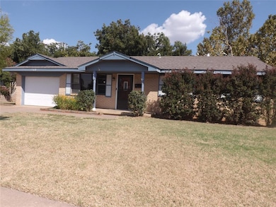 Ranch-style home with a front lawn, brick siding, a porch, a garage, and concrete driveway
