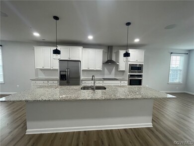 Kitchen with hanging light fixtures, white cabinet