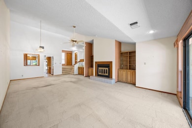 Unfurnished living room featuring visible vents, 