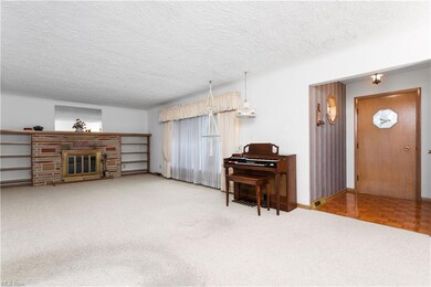 Foyer w/Coat Closet.  Large Living Room with Woodb