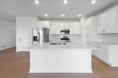 (Photo of a very similar home, actual finishes may vary)