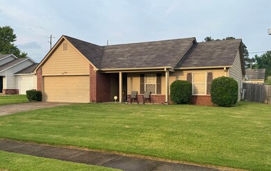 View of front of property with a garage, brick sid