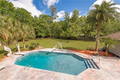 View of pool, patio, and back yard.