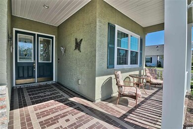 Covered front porch and entry way features a doubl