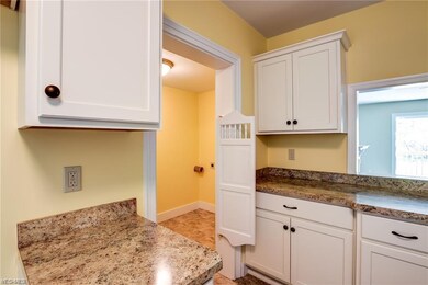 Updated Kitchen - swinging door to laundry - neutr