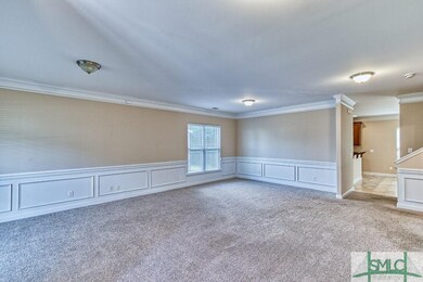 Huge living room with wainscoting and crown moldin