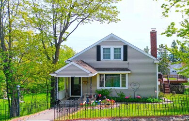 Bungalow-style home featuring covered porch, a chimney, and a shingled roof