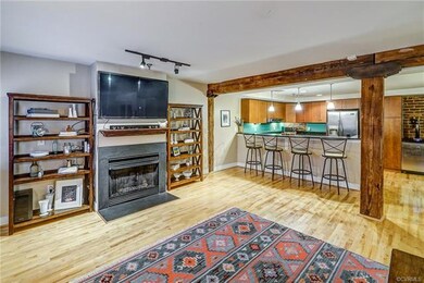 View of gas fireplace and exposed beams