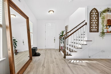 Foyer entrance featuring light wood-style flooring and stairs