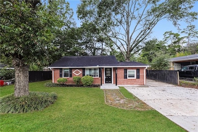 Ranch-style home featuring brick siding and concrete driveway