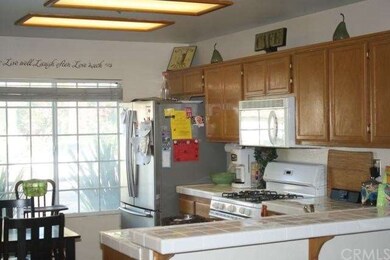 Bright and cheery kitchen has open plan.