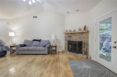 The Great Room features hardwood floors, a vaulted ceiling, a gas-log fireplace, and has plenty of room for furniture placement.
