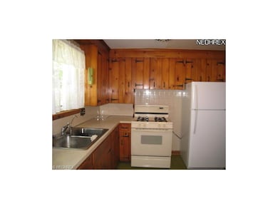 Applianced kitchen with new refrigerator.