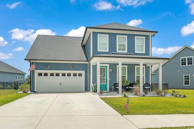 View of property with a porch, a garage, and a fro