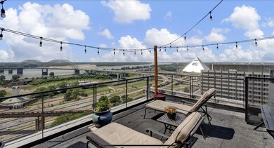 View of patio / terrace with a balcony and a water