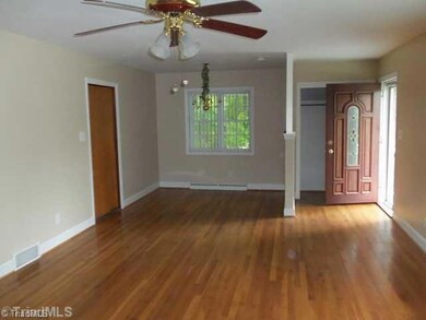 Living Room. This is looking back into the other end of the Living Room, to the dining area, notice the lovely front door and the 