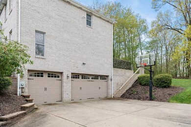 Extended concrete driveway and 3 car garage with 14 course block