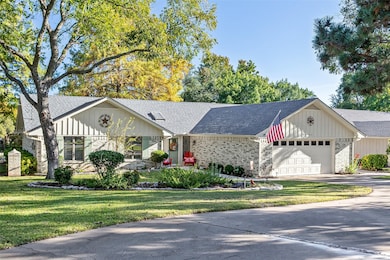 Single story home with roof with shingles, a front lawn, brick siding, and driveway