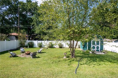 Fully fenced backyard with storage shed.