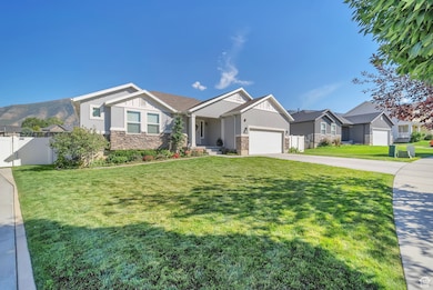 Craftsman house with stone siding, a residential view, concrete driveway, and an attached garage
