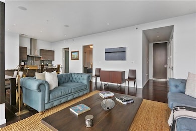 Living area featuring wood finished floors, baseboards, and recessed lighting