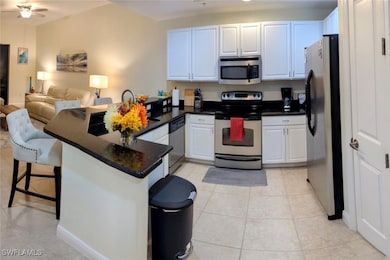 Kitchen featuring a breakfast bar, white cabinetry