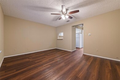 Spare room with ceiling fan, a textured ceiling, 