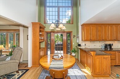 Kitchen featuring dark stone counters, tasteful ba