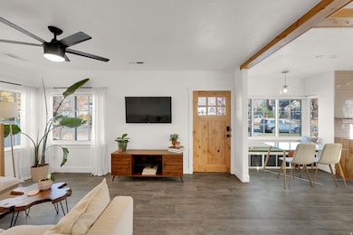 Living area with wood finished floors and ceiling fan