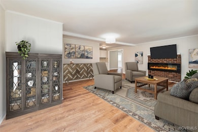 Living area with wood finished floors, a fireplace