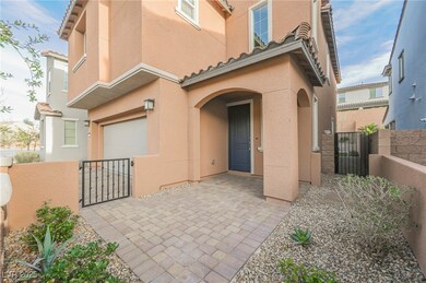 Entrance to property with a gate, an attached garage, and stucco siding