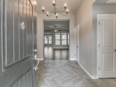 Foyer entrance with light wood-type flooring and c