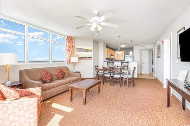 Living area with light colored carpet and ceiling 