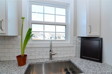 Large stainless steel sink and tile backsplash