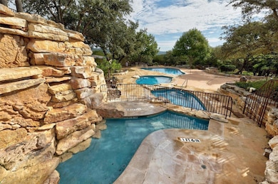 Community pool with a patio area, a hot tub, and 