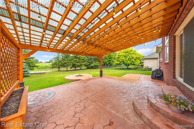 Beautiful red cedar pergola with flower bed and privacy wall