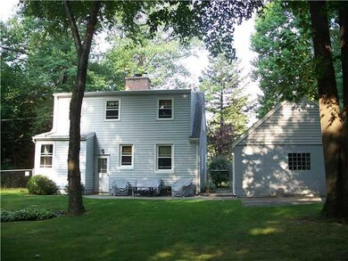 Exterior Back. View from the east, showing patio a