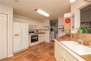 The kitchen has both slate flooring and slate counters.  There is lots of counter space and a pass-through to the living/dining areas.