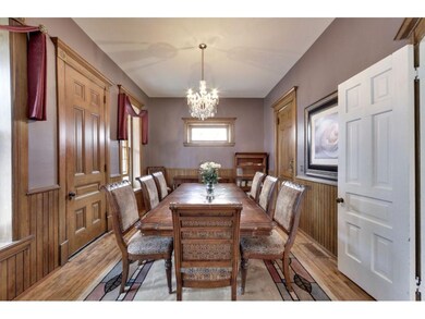 The formal dining room features intricate woodwork