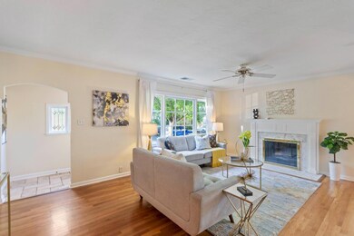 Living Room with hardwood floors and front door en